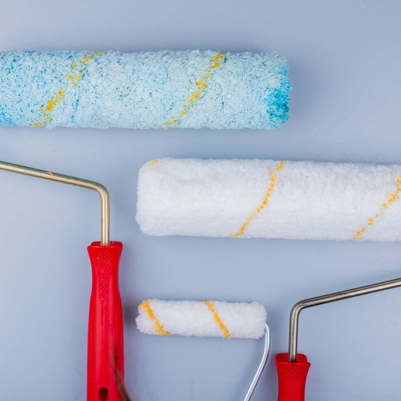 close-up-view-paint-rollers-gray-background-min